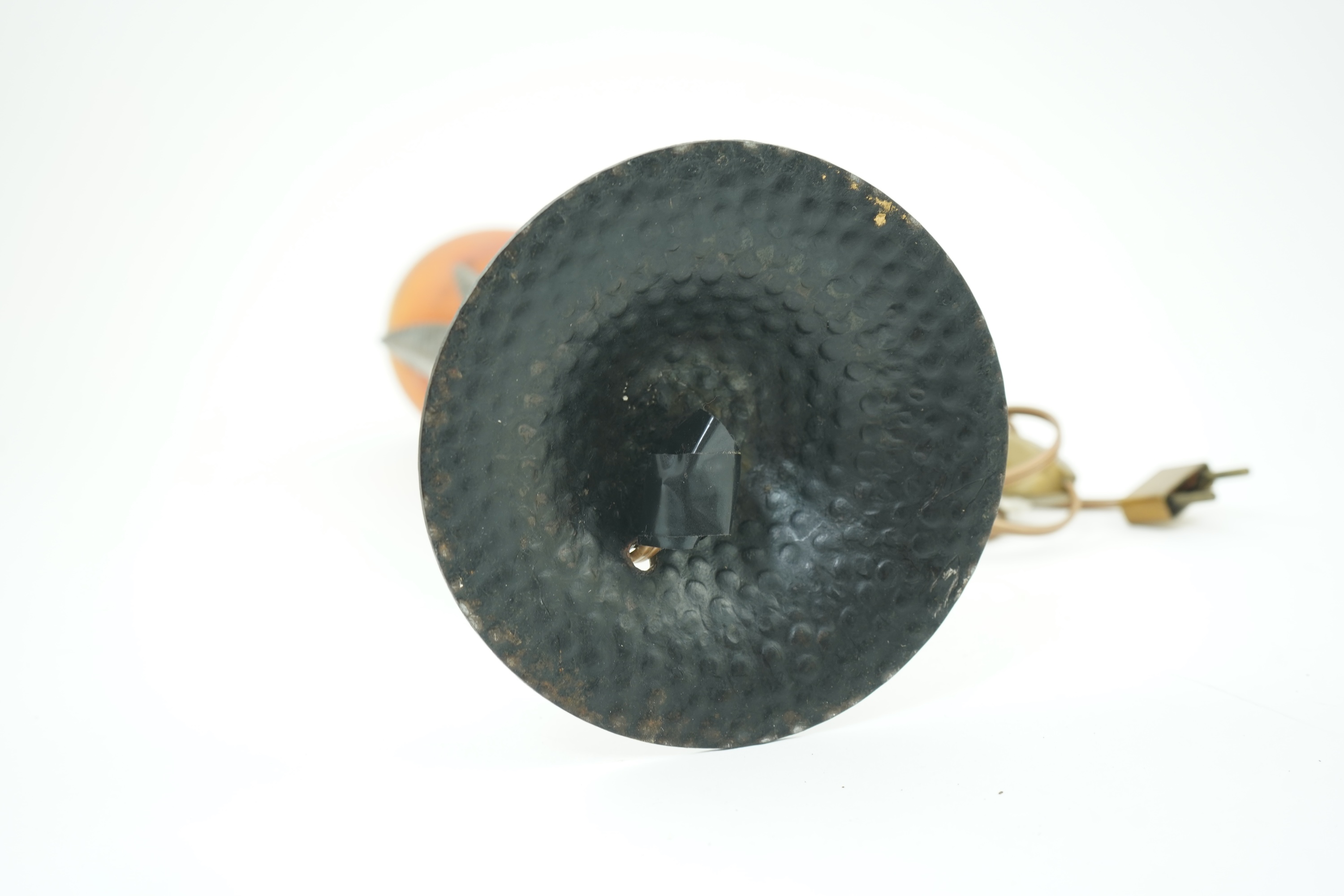 Manner of Muller Freres and Robj: A French Art Deco table lamp the mottled orange glass shade supported by naturalistic palm-leaf metal supports terminating in a circular hammered metal base, 40cm high